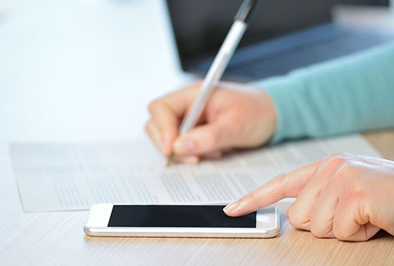 Mobile device with pen and paper in background thumbnail